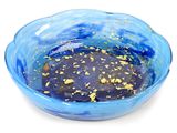 a blue bowl with gold flakes in it