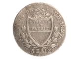 une vieille pièce d'argent sur laquelle figure un blason