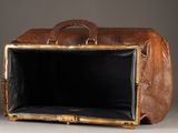 a large brown bag with a handle on a table