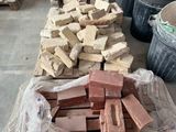 a pile of bricks sitting on the floor next to buckets