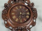 a wooden clock that is hanging on the wall