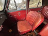 two red seats in the back of a red car
