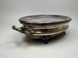 a silver plate with a bird on it on a stand