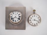 a silver clock and a silver pocket watch on a white surface