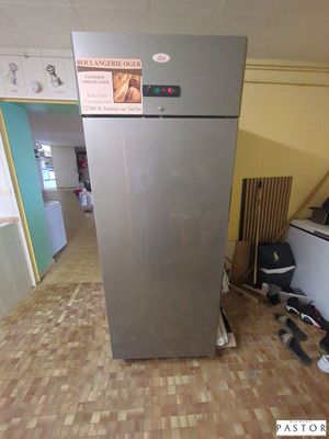 an image of a kitchen with a refrigerator in the middle of the floor