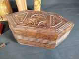 carved wooden box sitting on top of a table next to a pair of scissors