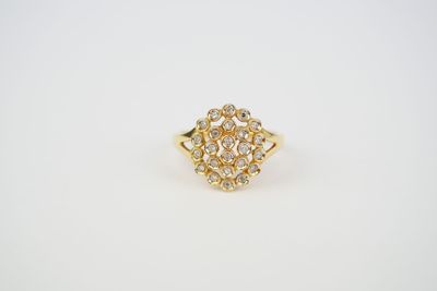 a yellow gold ring with a cluster of white diamonds