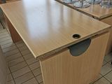 a wooden table with a hole in it in the middle of a room