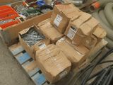 many boxes of screws and other tools on a pallet