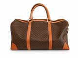 the brown and tan bag is sitting on a white surface