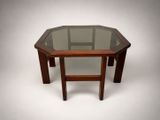 an octagonal glass table with wooden legs and a glass top