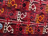 a red rug on the floor next to a person ' s feet