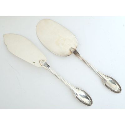 a pair of silver plated serving spoons with handles