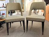two chairs sitting next to each other in a room
