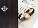a box with a watch and a certificate on it