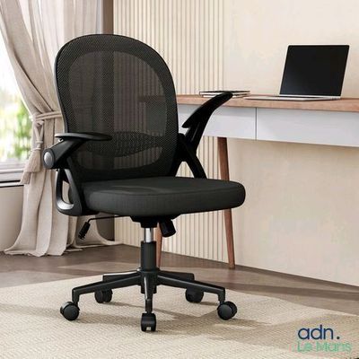 an image of a black office chair in front of a desk with a laptop