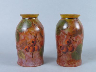 two vases sitting side by side on a white surface