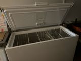a white chest freezer sitting in a kitchen