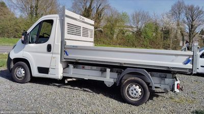 a white truck that is parked in the gravel