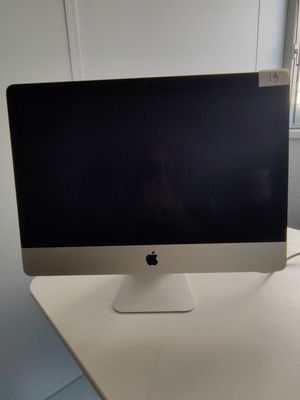 a computer monitor sitting on top of a white desk