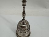 an antique silver plated candle holder on a white surface