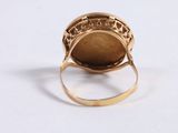 an image of a gold ring with a stone in the middle