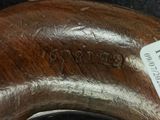 a close up of a wooden object with a tag on it