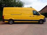 a yellow van that is parked in a parking lot