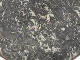 a close up of a black and white marble table top