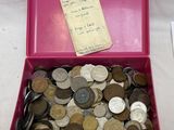 une boîte rose remplie de pièces de monnaie, avec un mot à l'intérieur