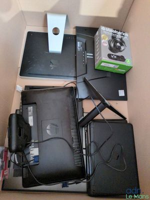 a box with laptops and other electronics on top of it