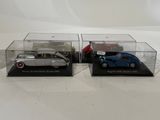 two model cars are sitting in clear boxes on a white surface
