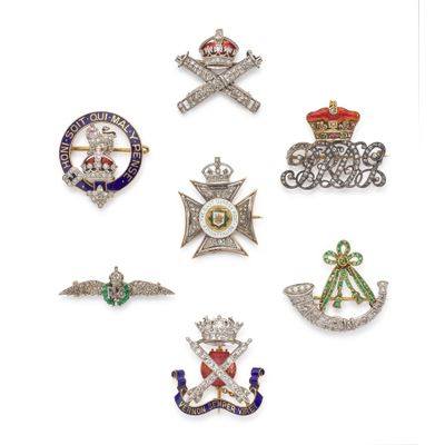 several different types of brooches are displayed on a white surface