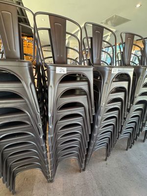 many chairs stacked on top of each other in a store
