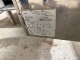 a label on the back of a machine that is sitting on the floor