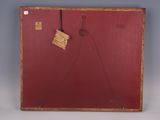an old red suitcase with a tag hanging from it ' s side