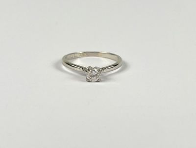 a white gold ring with a single diamond