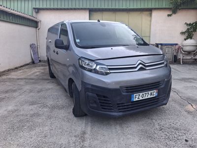 citroen van parked in front of a building in a parking lot