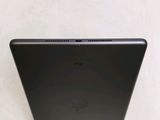 the back of a black laptop computer sitting on top of a table