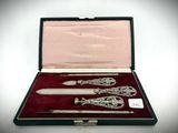 a silverware set in a case on a white surface