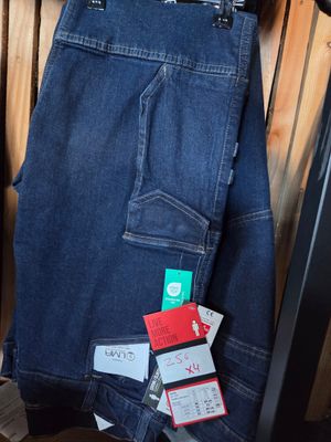 a pair of jeans hanging on a rack in a room