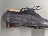 grey leather shoes hanging on a wall in a room