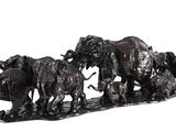 a group of elephants that are standing together on a table