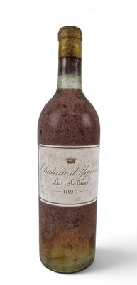 an old bottle of wine sitting on top of a white surface