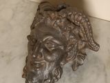 a statue of a man ' s head on a marble table