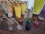 many different colored glassware sitting on a wooden table