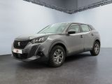 a grey car parked in a garage with a white wall