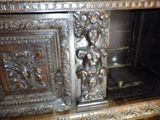 a wooden cabinet with carvings on the front of it