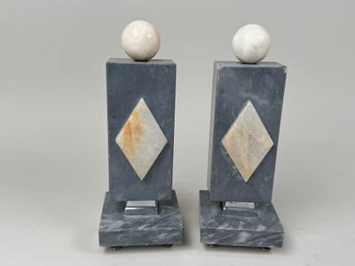 pair of marble bookends with marble balls on top of them