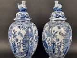 pair of blue and white vases with birds on them